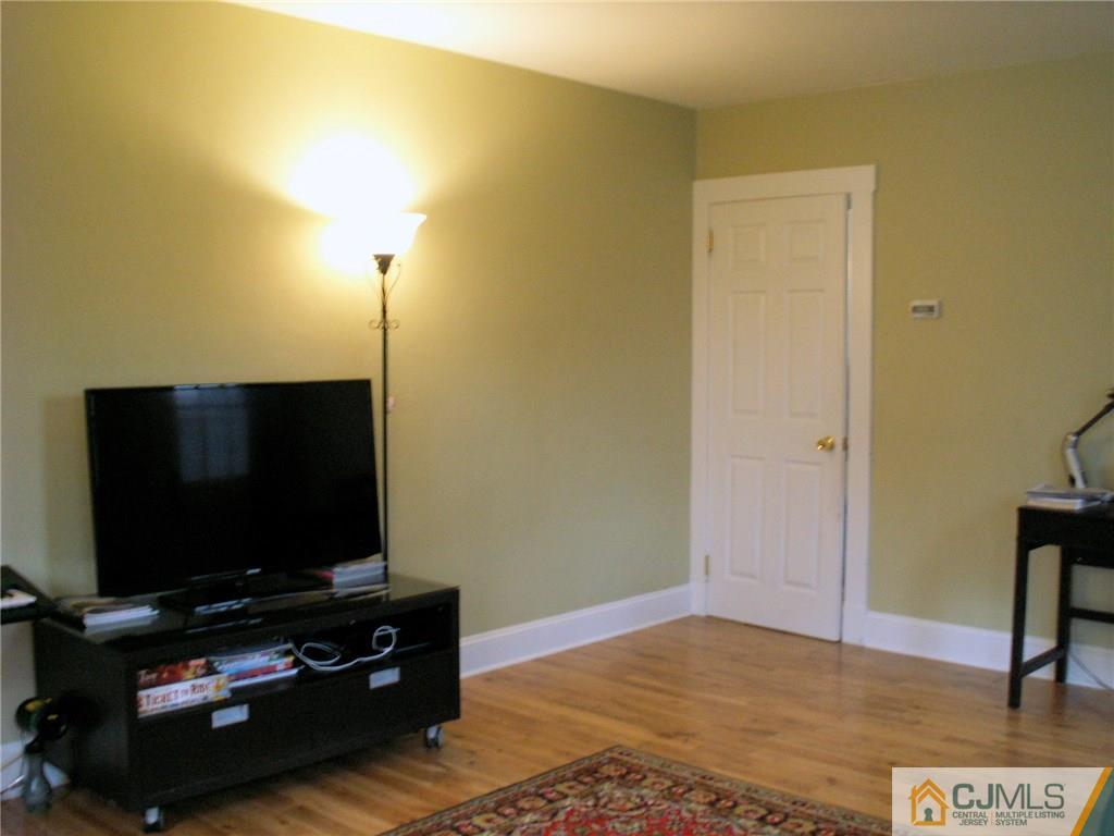 339 Plainsboro Road Plainsboro, NJ 08536 - Photo 4 of 16 a living room with furniture and a flat screen tv