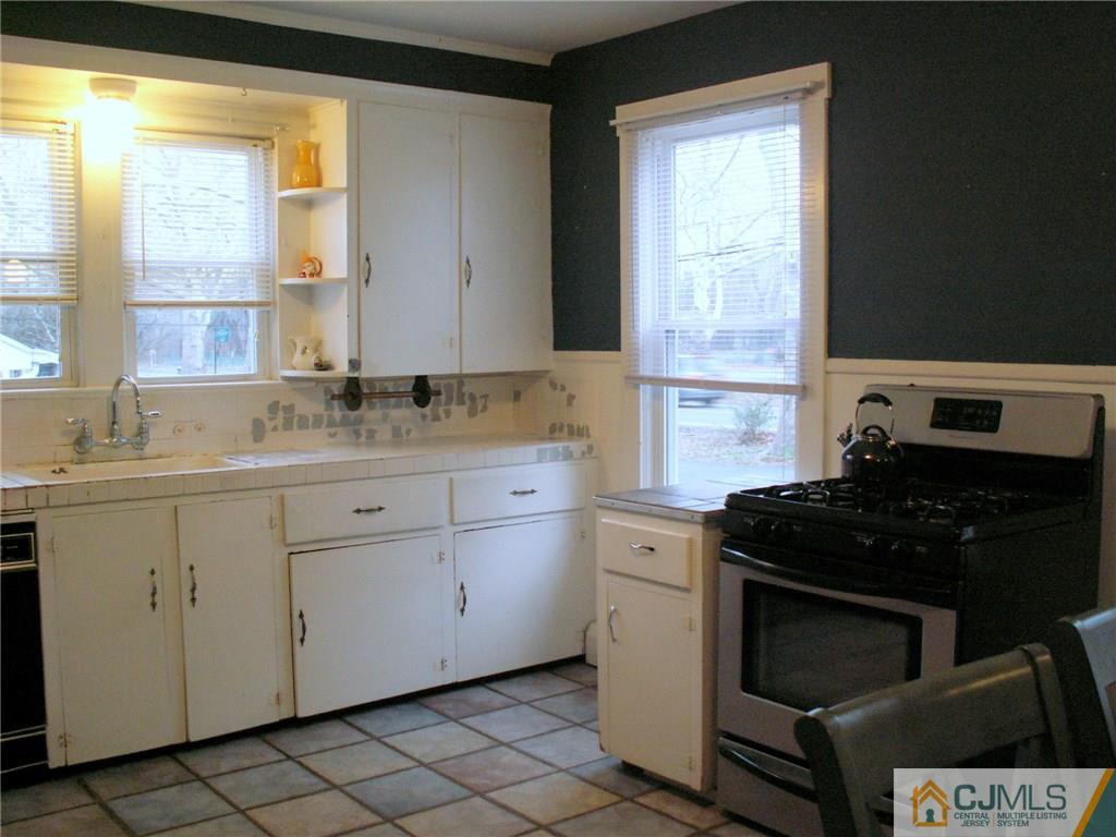 339 Plainsboro Road Plainsboro, NJ 08536 - Photo 7 of 16 a kitchen with granite countertop white cabinets and a stove top oven