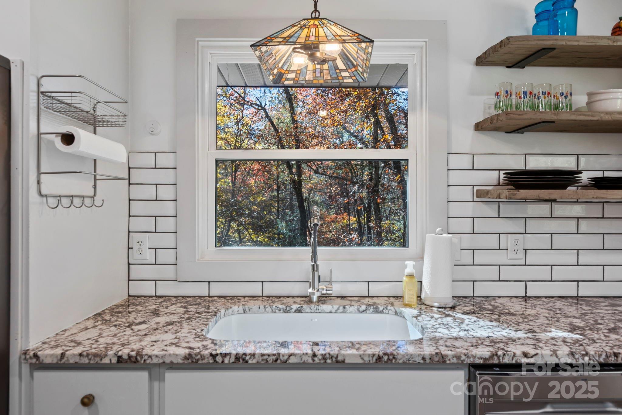 2149 Williamson Creek Road Pisgah Forest, NC 28768 - Photo 14 of 38 a bathroom with a granite countertop sink and a window