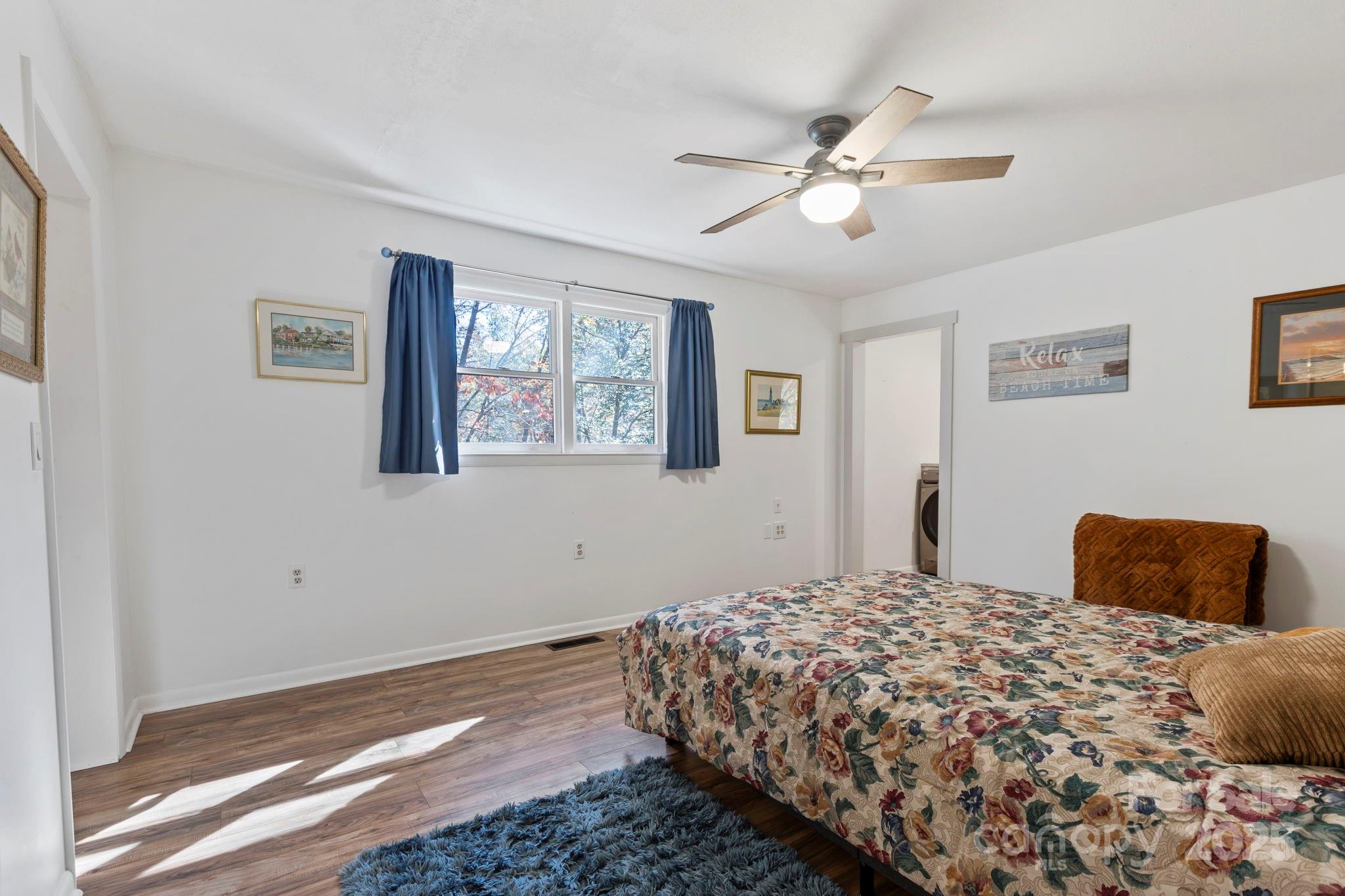 2149 Williamson Creek Road Pisgah Forest, NC 28768 - Photo 16 of 38 a bedroom with a large bed and a window