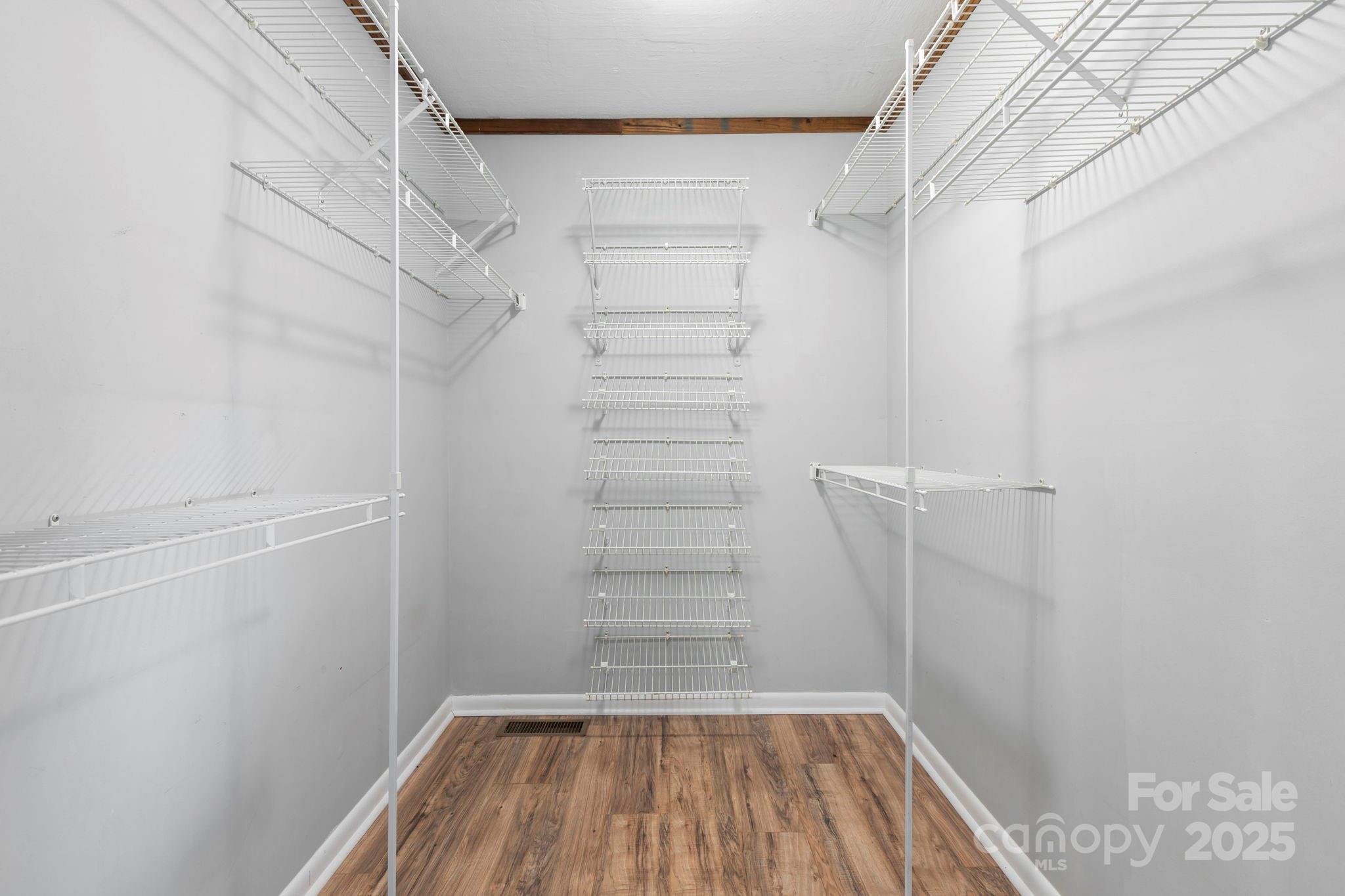 2149 Williamson Creek Road Pisgah Forest, NC 28768 - Photo 19 of 38 a view of walk in closet with empty racks