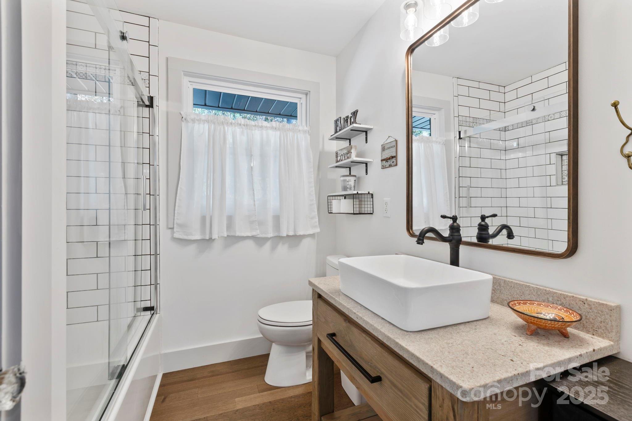 2149 Williamson Creek Road Pisgah Forest, NC 28768 - Photo 22 of 38 a bathroom with a sink toilet and shower