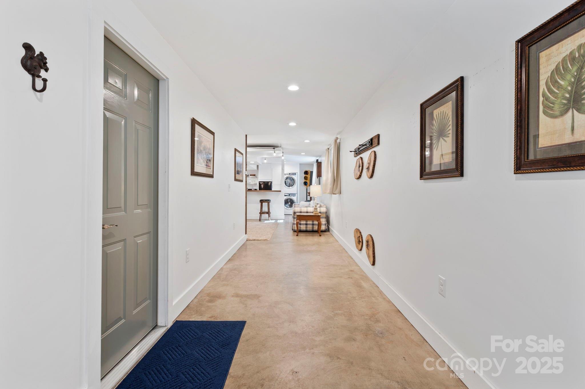 2149 Williamson Creek Road Pisgah Forest, NC 28768 - Photo 25 of 38 a hallway with wooden floor and windows