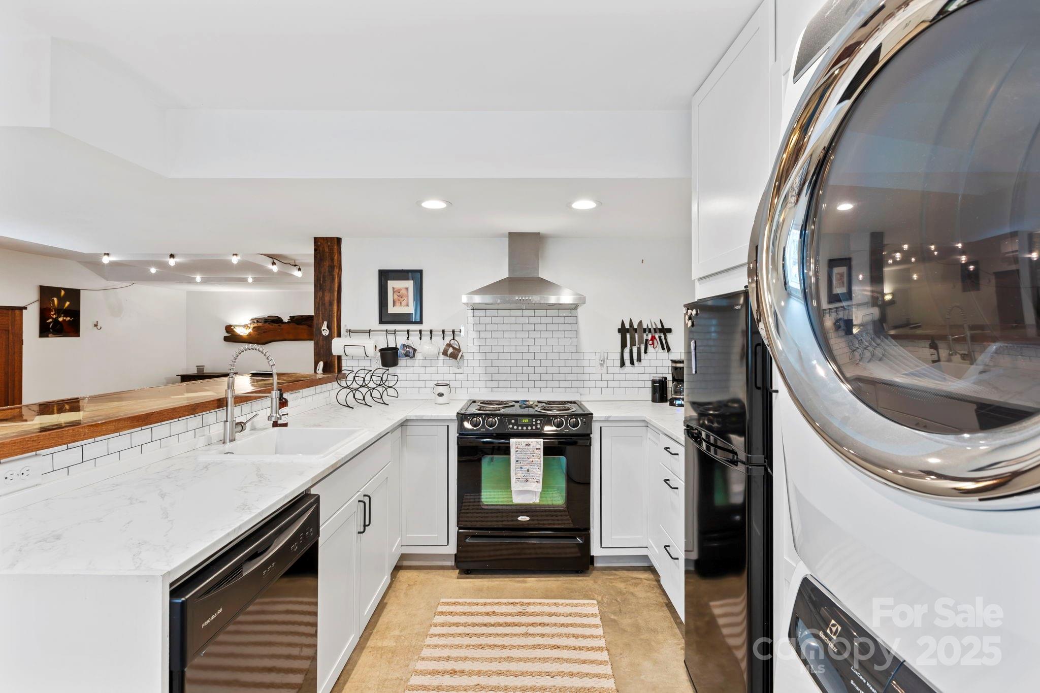 2149 Williamson Creek Road Pisgah Forest, NC 28768 - Photo 30 of 38 a kitchen with a sink and cabinets