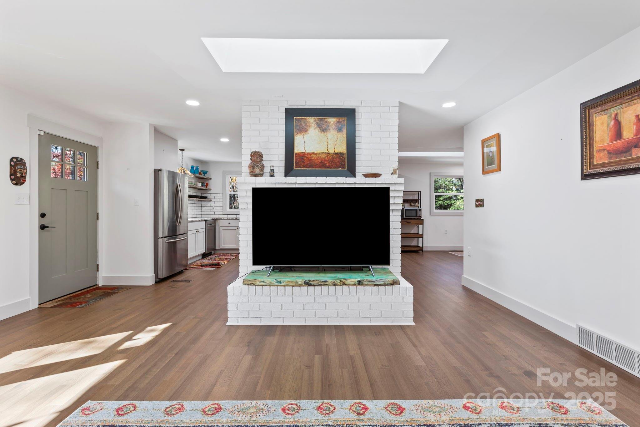 2149 Williamson Creek Road Pisgah Forest, NC 28768 - Photo 9 of 38 a living room with furniture a rug and a flat screen tv
