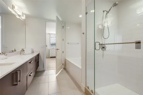 a bathroom with a double vanity sink and a mirror