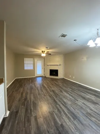 a view of empty room with a fireplace