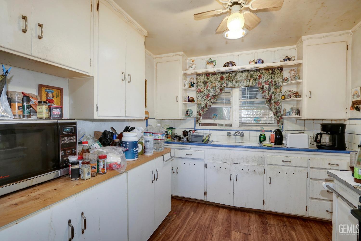 Undisclosed Address Sacramento, CA 95821 - Photo 12 of 33 a kitchen that has a lot of cabinets and wooden floor