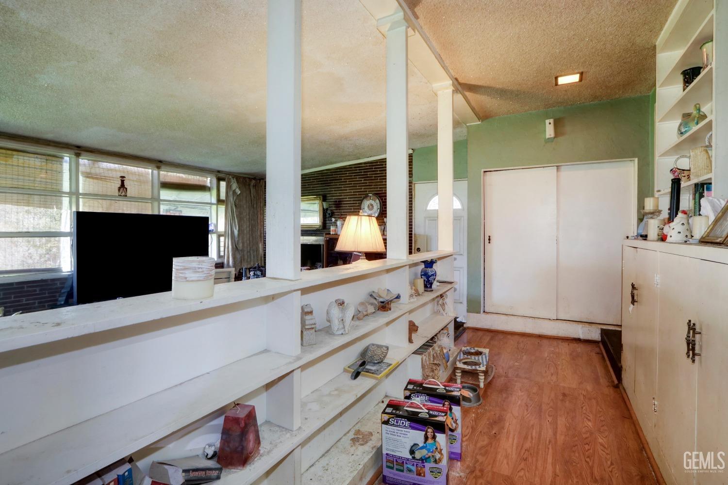 Undisclosed Address Sacramento, CA 95821 - Photo 9 of 33 a large kitchen with granite countertop a refrigerator a sink and dishwasher with wooden floor