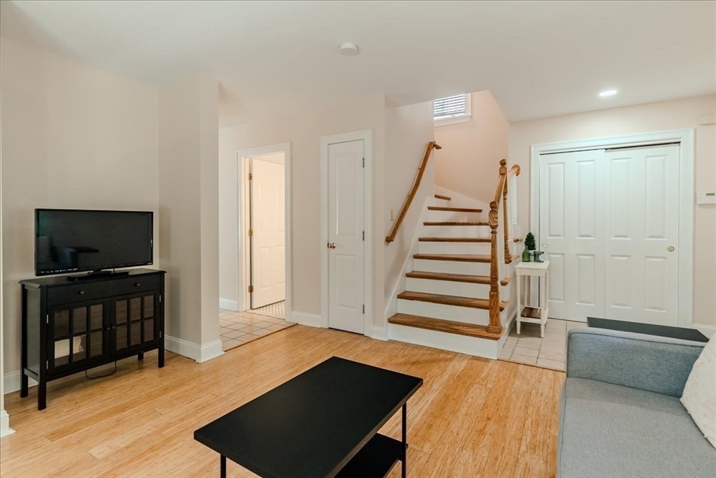 59 Fulda Street, Unit A Boston, MA 02119 - Photo 5 of 18 a view of a livingroom with furniture and staircase