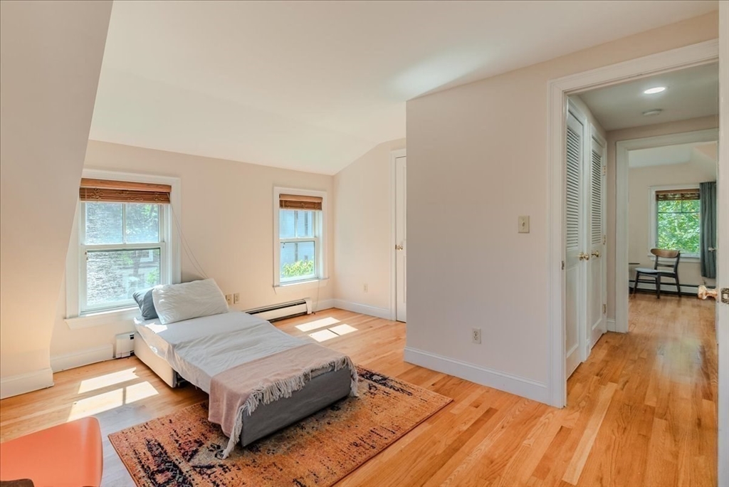 59 Fulda Street, Unit A Boston, MA 02119 - Photo 7 of 18 a bedroom with a bed and wooden floor