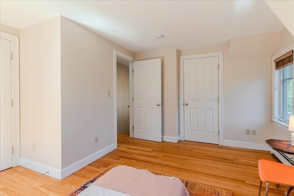 59 Fulda Street, Unit A Boston, MA 02119 - Photo 8 of 18 a view of a livingroom with wooden floor and closet