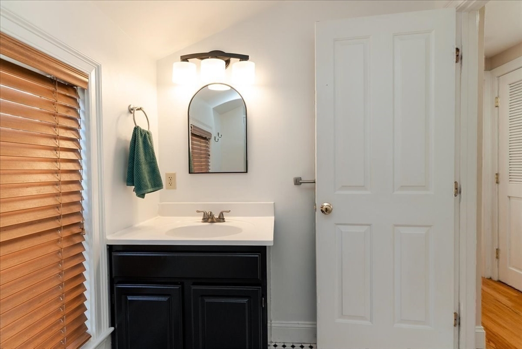 59 Fulda Street, Unit A Boston, MA 02119 - Photo 9 of 18 a bathroom with a sink and a mirror