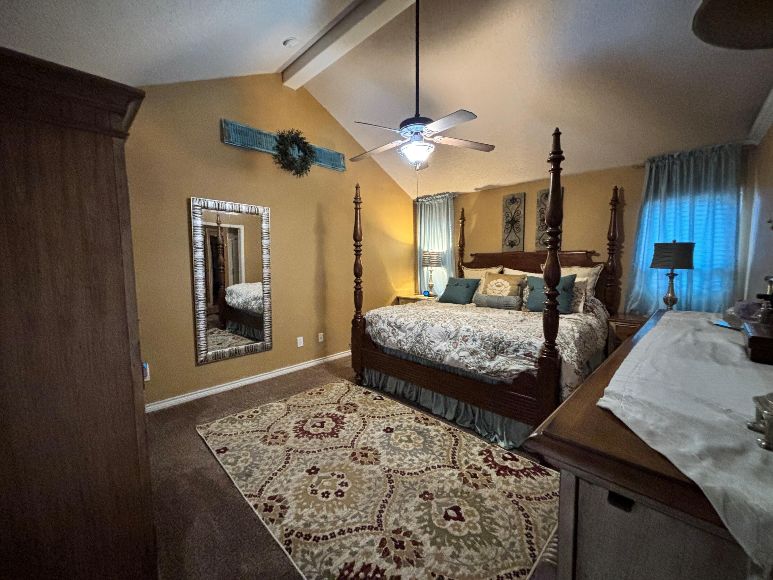 3713 106th Street Lubbock, TX 79423 - Photo 8 of 22 a bedroom with a bed ceiling fan and a wooden floor