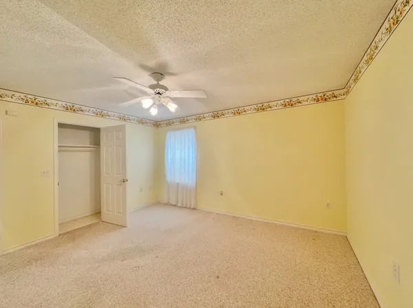 a view of walk in closet and bedroom
