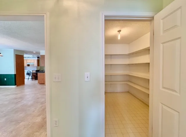 a view of walk in closet and bedroom