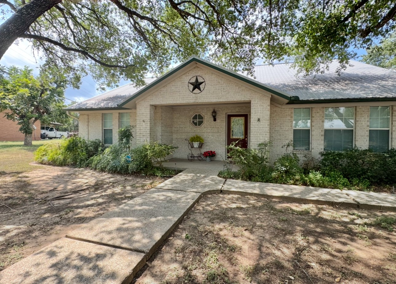 608 Mogonye Lane Elgin, TX 78621 - Photo 37 of 38 a front view of house with yard and trees around