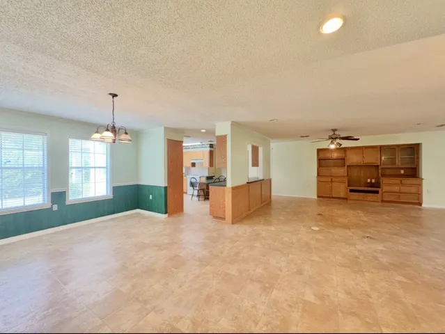 an empty room with furniture and a flat screen tv