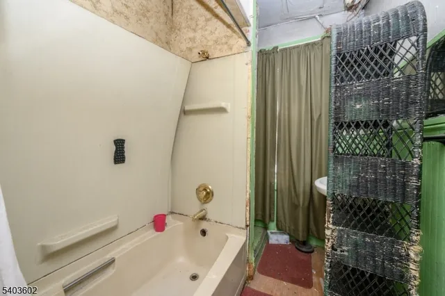 a view of a white house with a large windows and lawn chairs