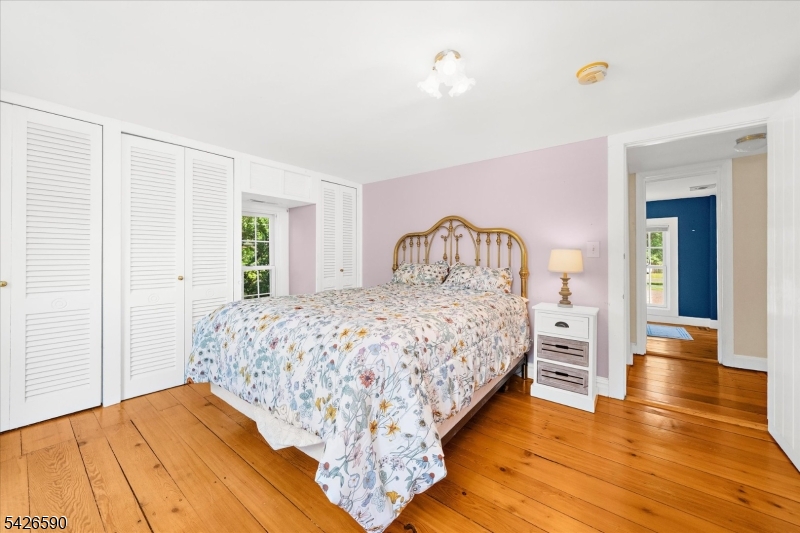 179 Lindbergh Road Hopewell, NJ 08525 - Photo 27 of 46 a bedroom with a bed and wooden floor