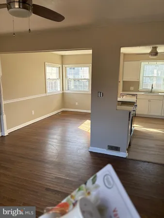 a view of a room with wooden floor and a window