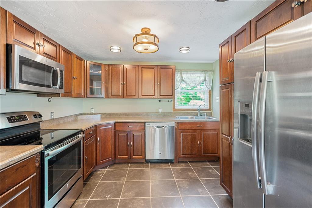 635 Center New Texas Road Pittsburgh, PA 15239 - Photo 7 of 22 a kitchen with stainless steel appliances granite countertop a stove a refrigerator and a sink