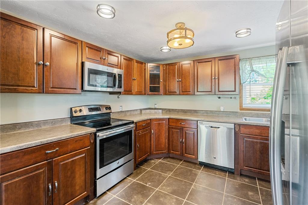 635 Center New Texas Road Pittsburgh, PA 15239 - Photo 8 of 22 a kitchen with stainless steel appliances granite countertop a stove sink and microwave