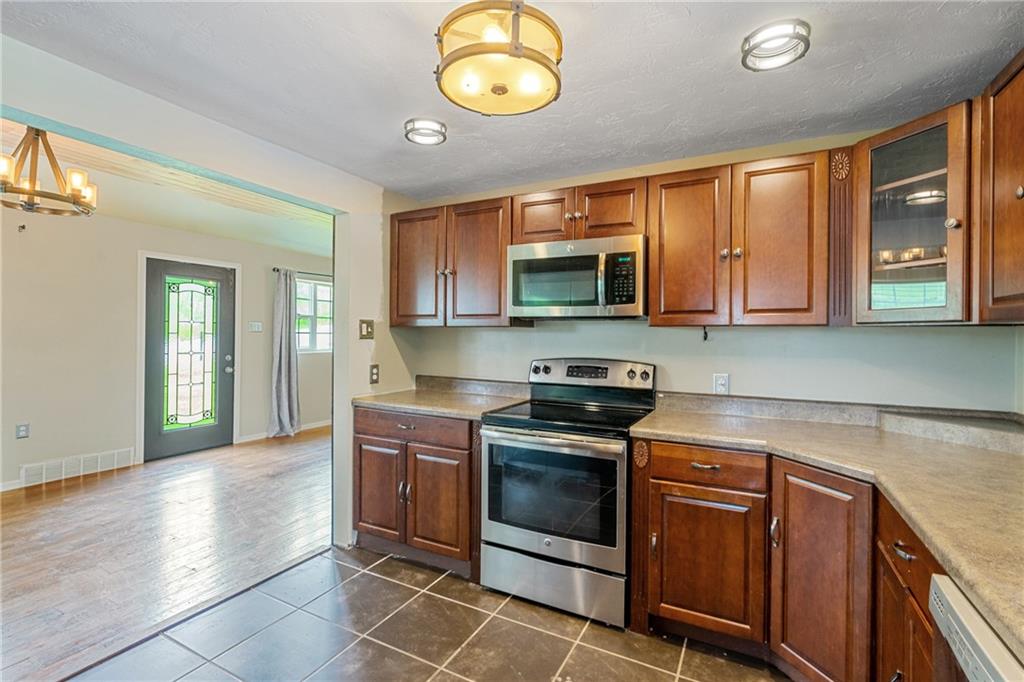 635 Center New Texas Road Pittsburgh, PA 15239 - Photo 9 of 22 a kitchen with stainless steel appliances granite countertop a stove a sink and a microwave