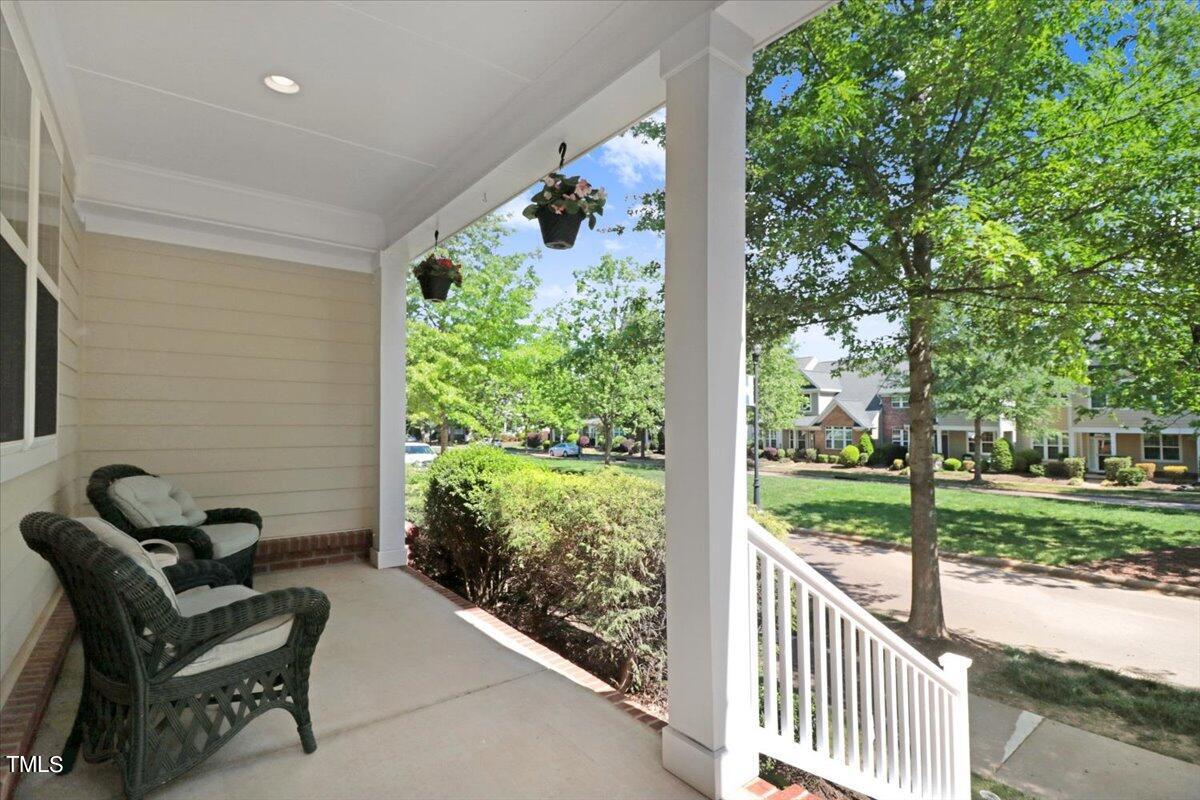 613 Democracy Street Raleigh, NC 27603 - Photo 5 of 45 a view of a porch with furniture and a yard