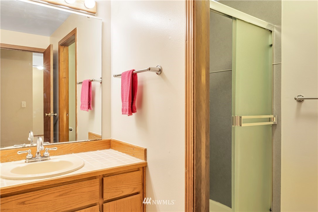 25419 213th Place Southeast, Unit 60 Maple Valley, WA 98038 - Photo 16 of 27 a bathroom with a sink vanity and a mirror