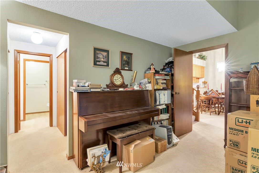 25419 213th Place Southeast, Unit 60 Maple Valley, WA 98038 - Photo 17 of 27 a living room with furniture a flat screen tv and a table