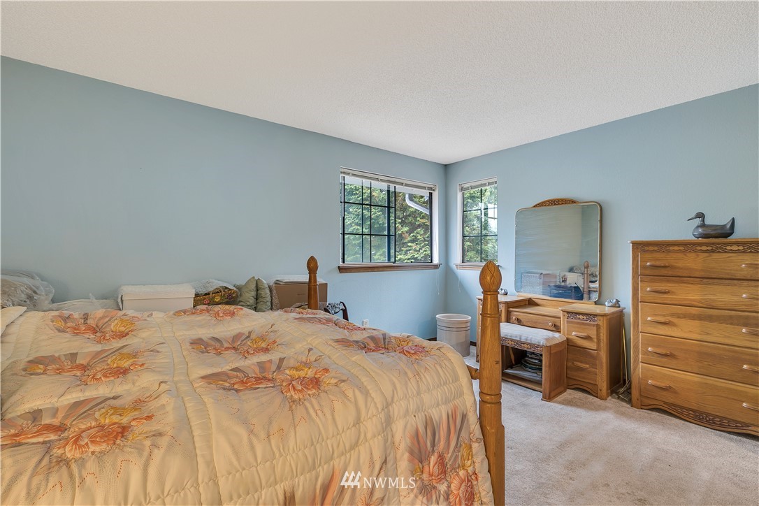 25419 213th Place Southeast, Unit 60 Maple Valley, WA 98038 - Photo 18 of 27 a bedroom with a bed and a dresser