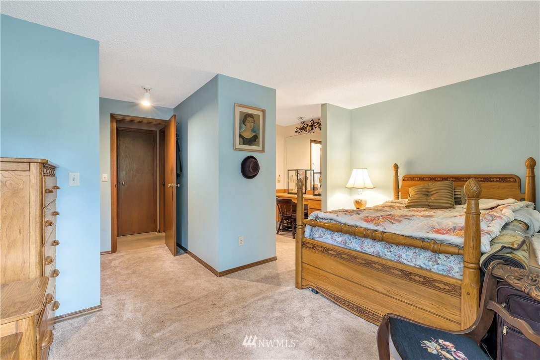 25419 213th Place Southeast, Unit 60 Maple Valley, WA 98038 - Photo 19 of 27 a bedroom with a bed and a mirror