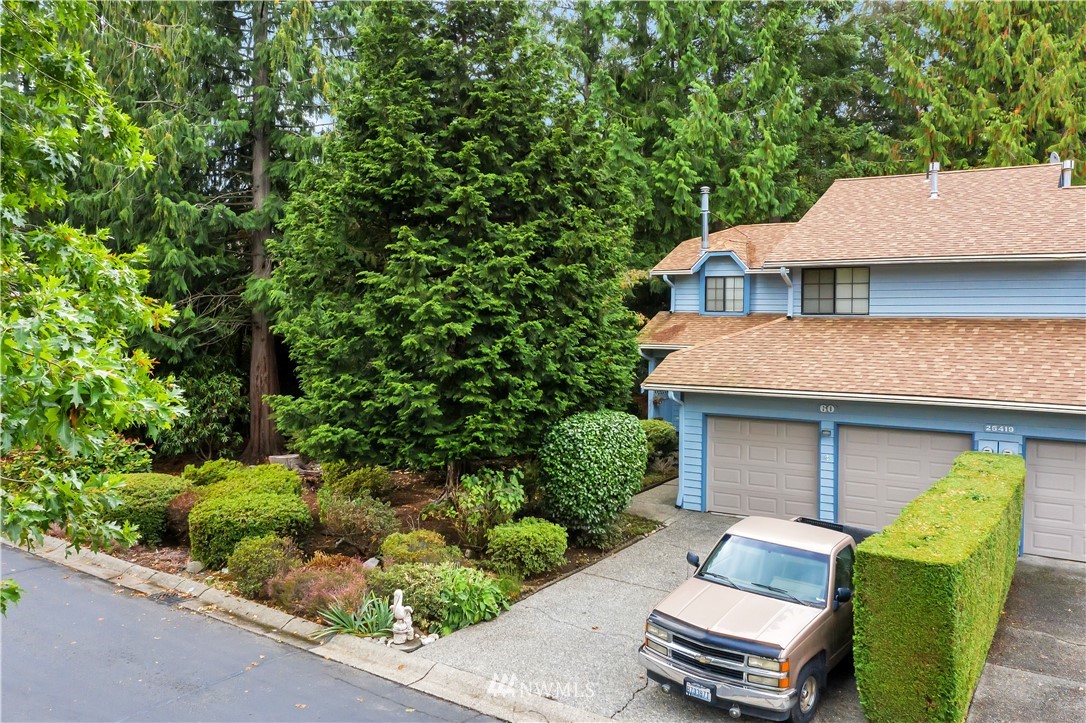 25419 213th Place Southeast, Unit 60 Maple Valley, WA 98038 - Photo 25 of 27 front view of a house with a garden