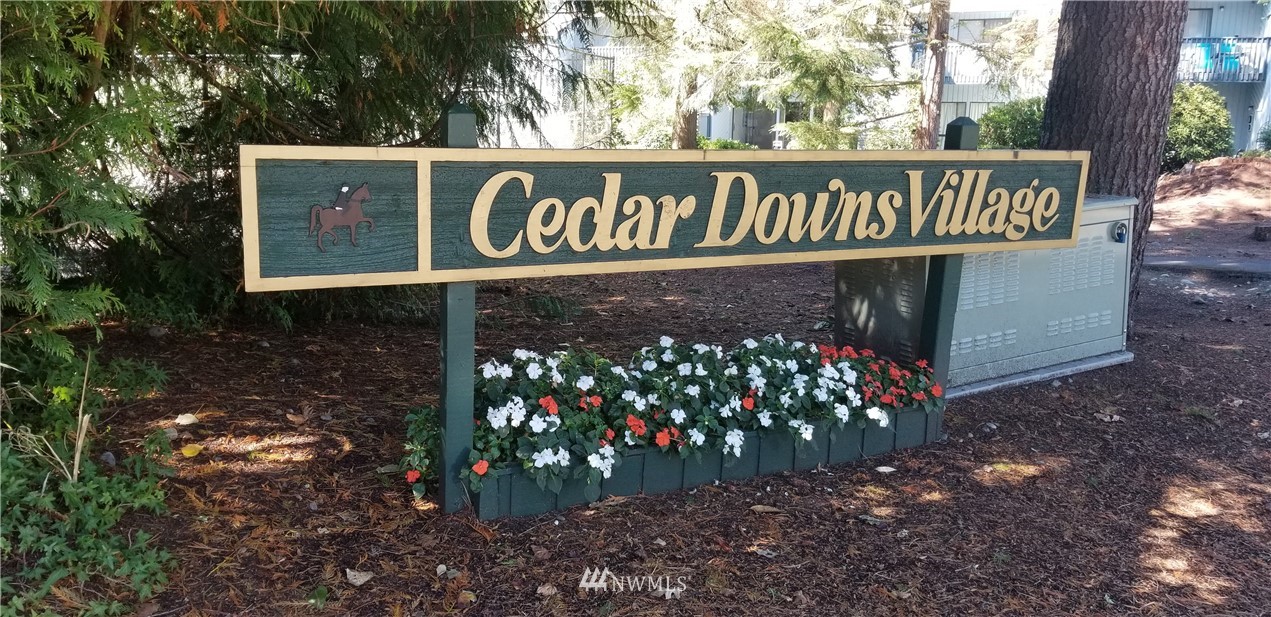 25419 213th Place Southeast, Unit 60 Maple Valley, WA 98038 - Photo 27 of 27 a street sign that is sitting in the middle of forest
