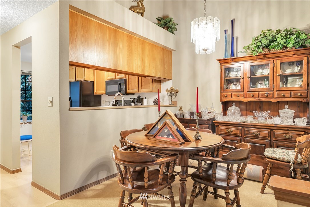 25419 213th Place Southeast, Unit 60 Maple Valley, WA 98038 - Photo 9 of 27 a view of a dining room with furniture and chandelier