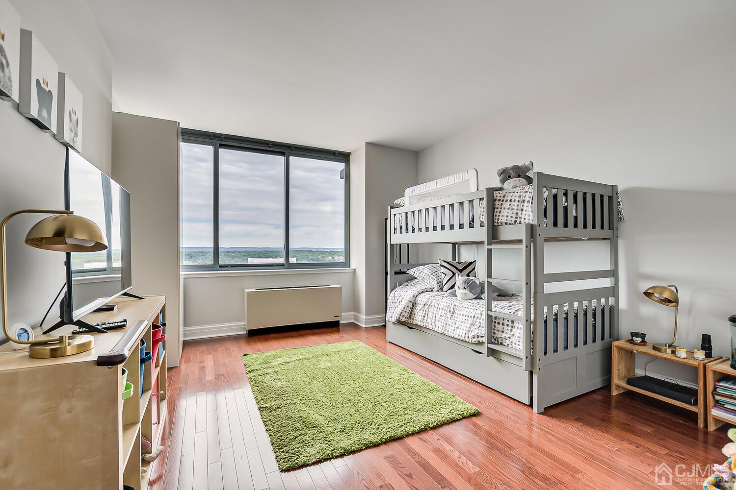 1 Spring Street, Unit 1806 New Brunswick, NJ 08901 - Photo 25 of 57 a bedroom with furniture and a window