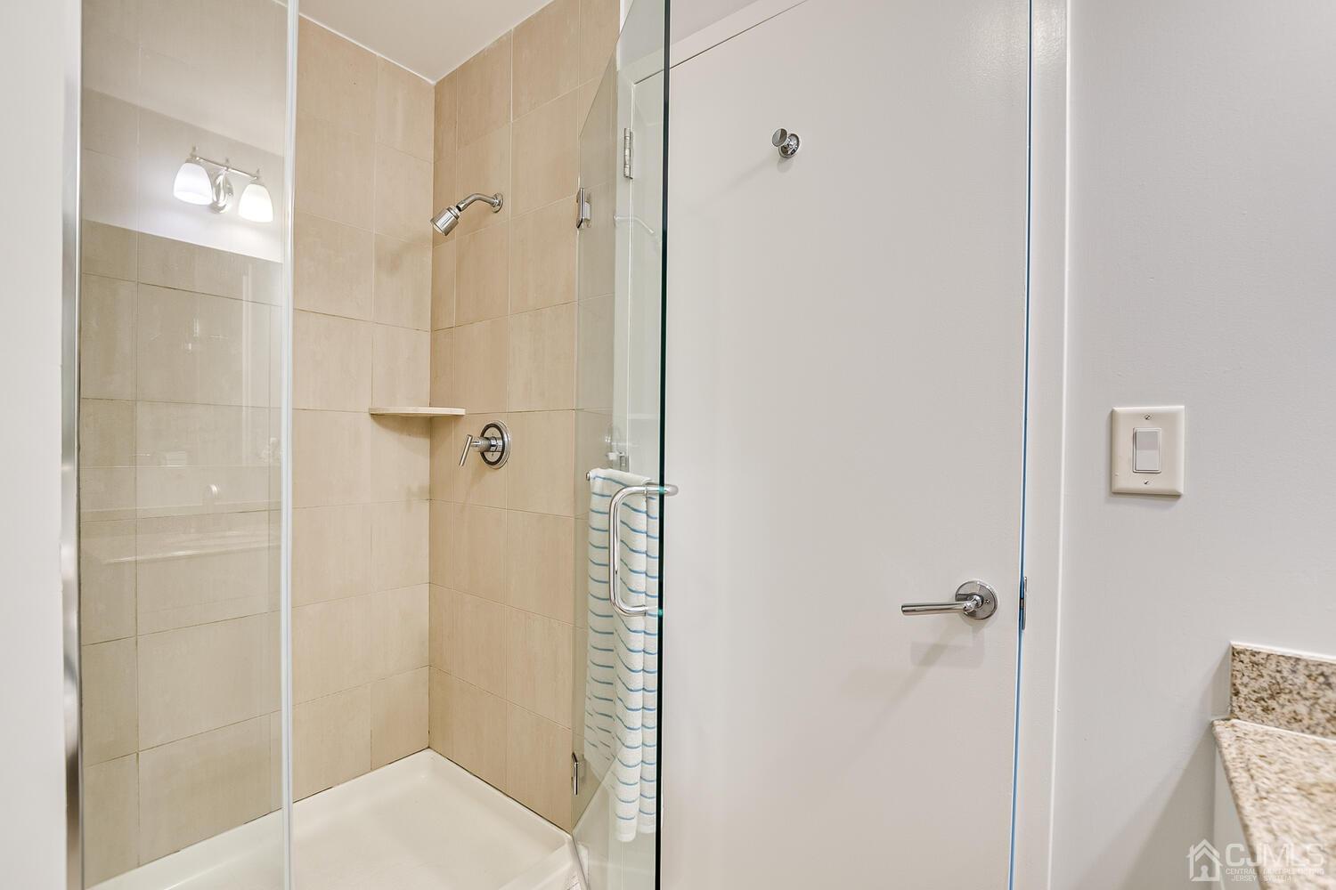 1 Spring Street, Unit 1806 New Brunswick, NJ 08901 - Photo 32 of 57 a bathroom with a shower