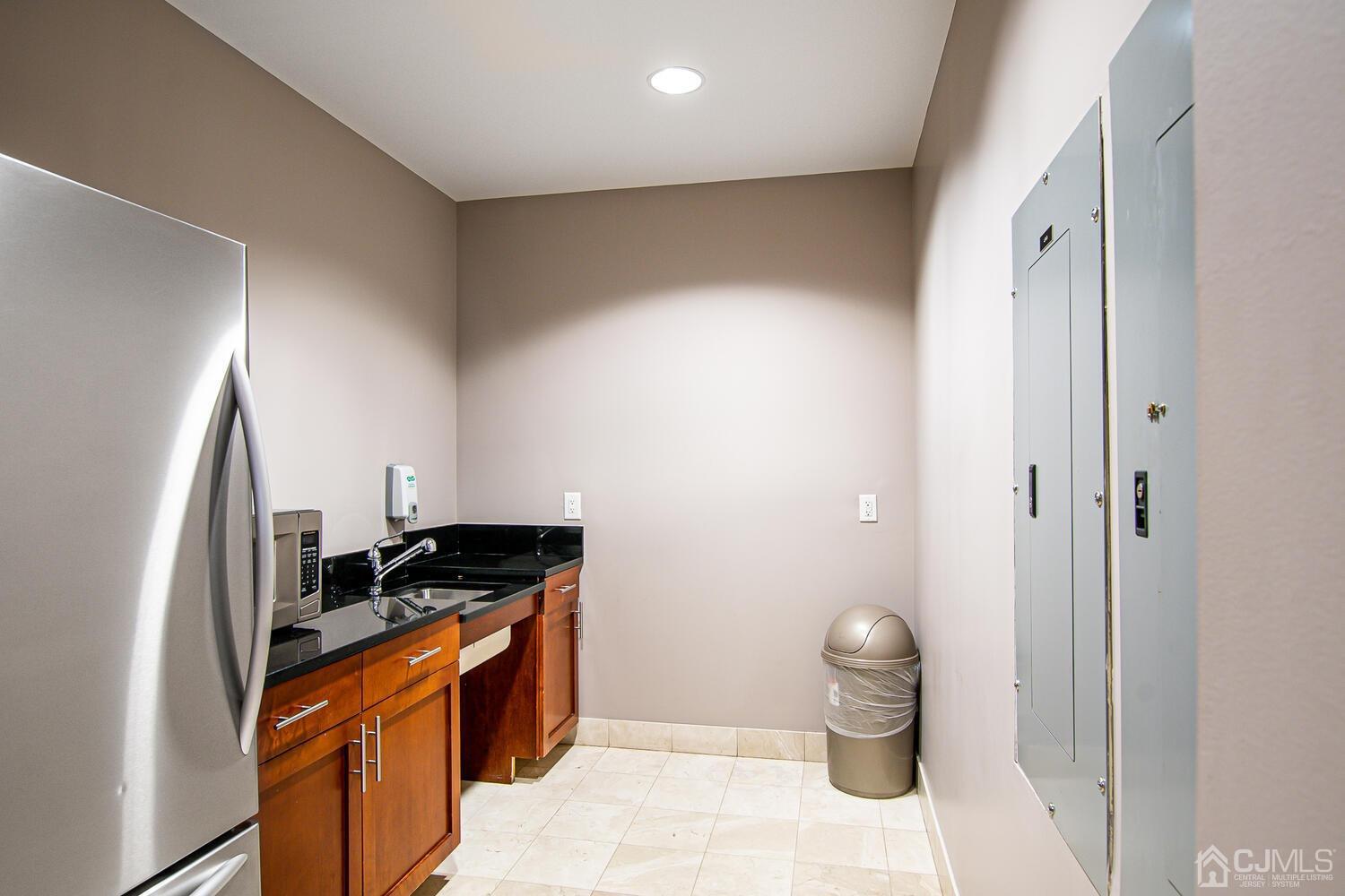 1 Spring Street, Unit 1806 New Brunswick, NJ 08901 - Photo 44 of 57 a kitchen with a refrigerator and a sink