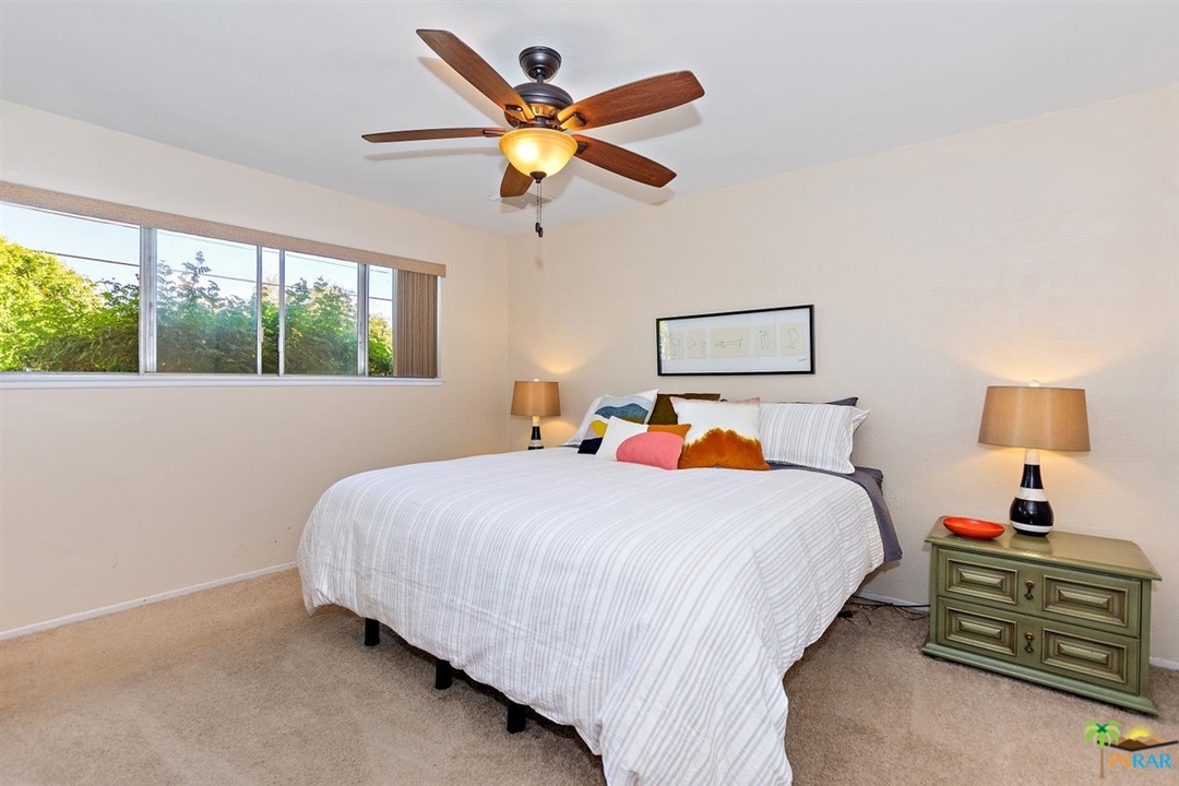 2802 North Chuperosa Road Palm Springs, CA 92262 - Photo 12 of 25 a bedroom with a bed and a large window