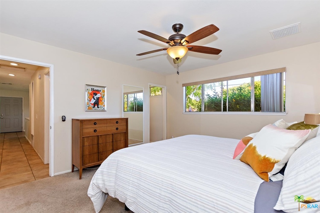 2802 North Chuperosa Road Palm Springs, CA 92262 - Photo 13 of 25 a bedroom with a bed and a chandelier