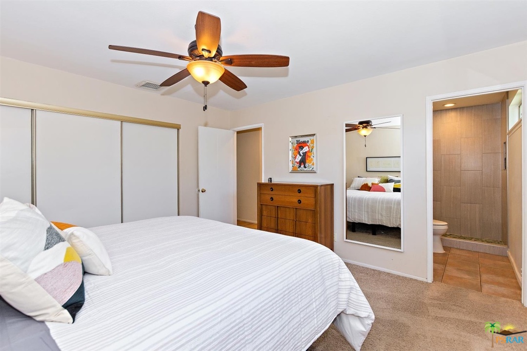 2802 North Chuperosa Road Palm Springs, CA 92262 - Photo 14 of 25 a bedroom with a bed and a chandelier