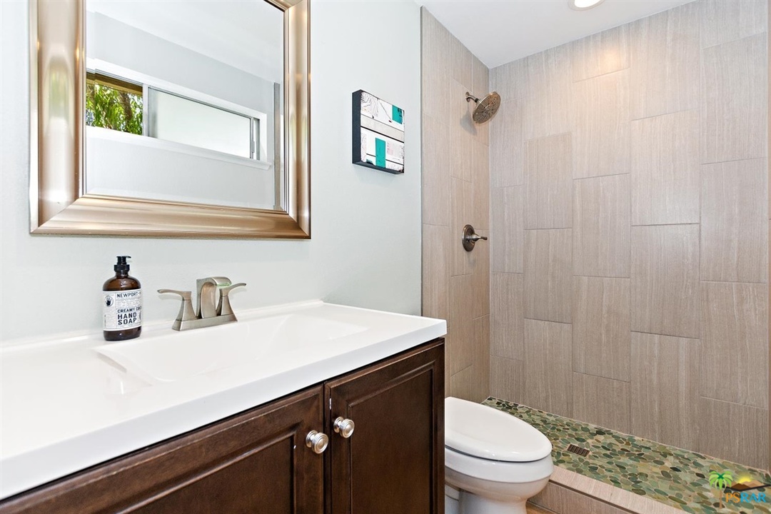 2802 North Chuperosa Road Palm Springs, CA 92262 - Photo 15 of 25 a bathroom with a sink a toilet a vanity and shower