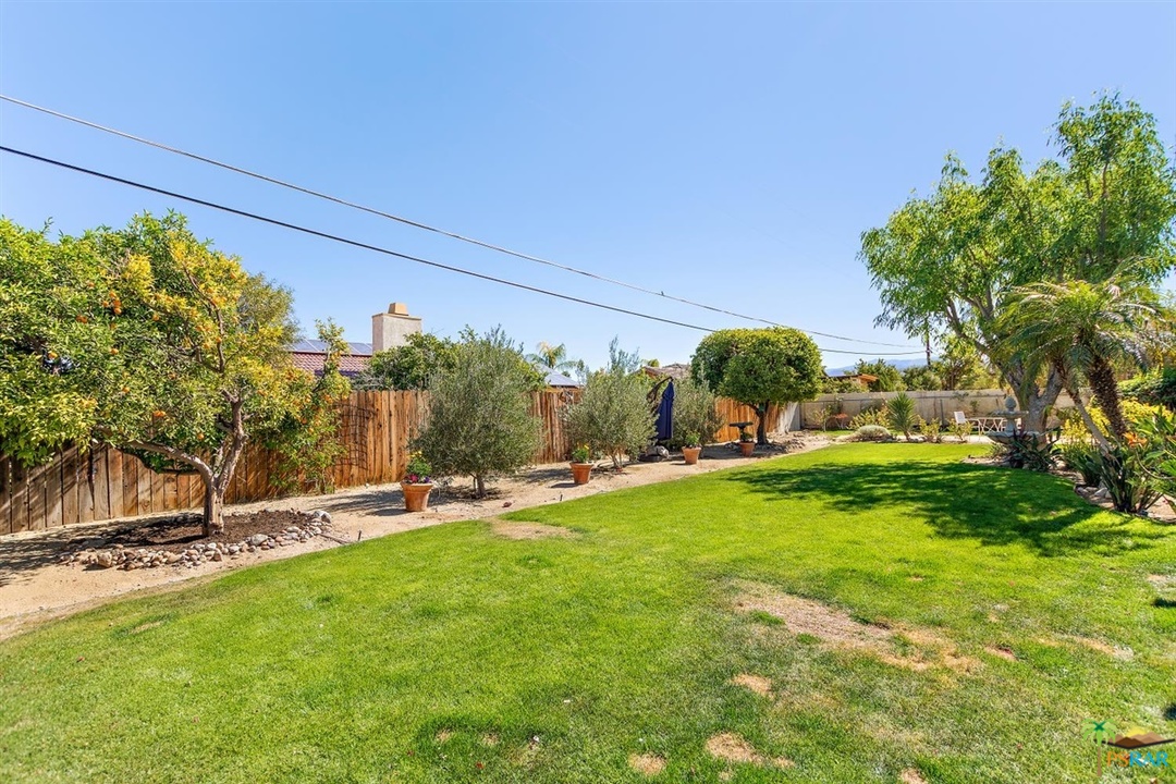 2802 North Chuperosa Road Palm Springs, CA 92262 - Photo 18 of 25 a backyard of a house with table and chairs