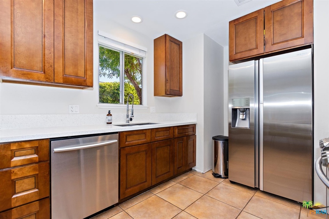 2802 North Chuperosa Road Palm Springs, CA 92262 - Photo 7 of 25 a kitchen with stainless steel appliances granite countertop a refrigerator and a sink