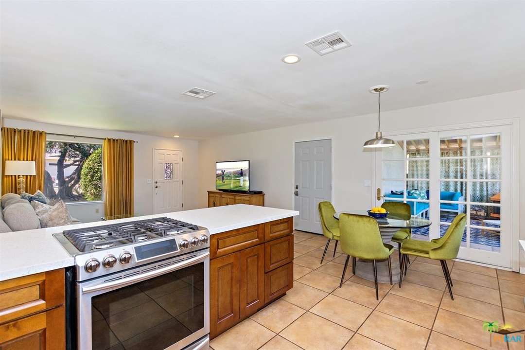 2802 North Chuperosa Road Palm Springs, CA 92262 - Photo 8 of 25 a kitchen with a stove and chairs