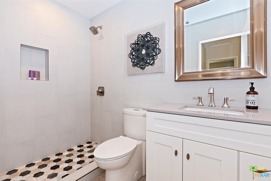 2802 North Chuperosa Road Palm Springs, CA 92262 - Photo 9 of 25 a bathroom with a granite countertop toilet sink and mirror