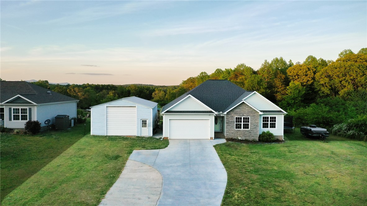 696 Mt Olivet Road Six Mile, SC 29682 - Photo 2 of 35 This captivating residence features a spacious driveway and an expansive yard, complemented by distant mountain views.