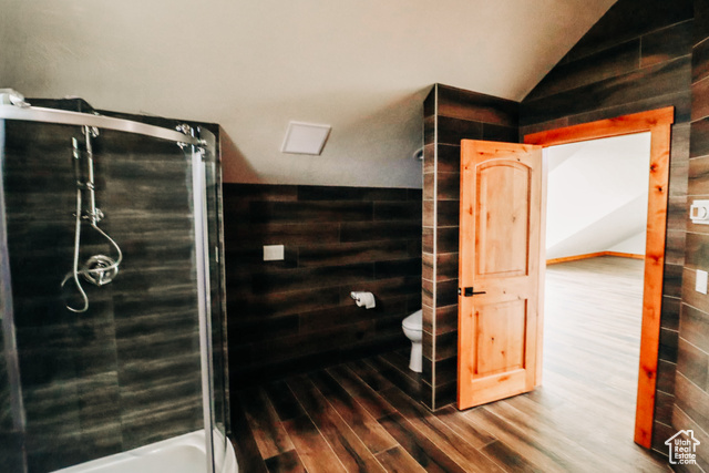 985 Russell Road Hatch, UT 84735 - Photo 24 of 30 Bathroom featuring lofted ceiling, a stall shower, wood finished floors, and wood walls