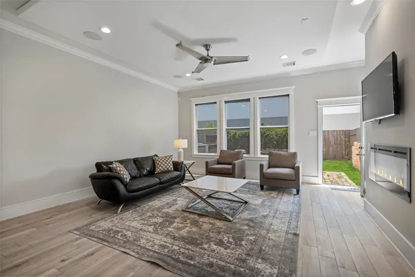 a living room with fireplace furniture and a flat screen tv